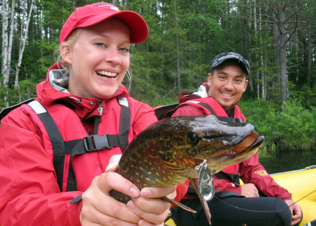 Girl fishing pike in swedish lapland with creactive advenure